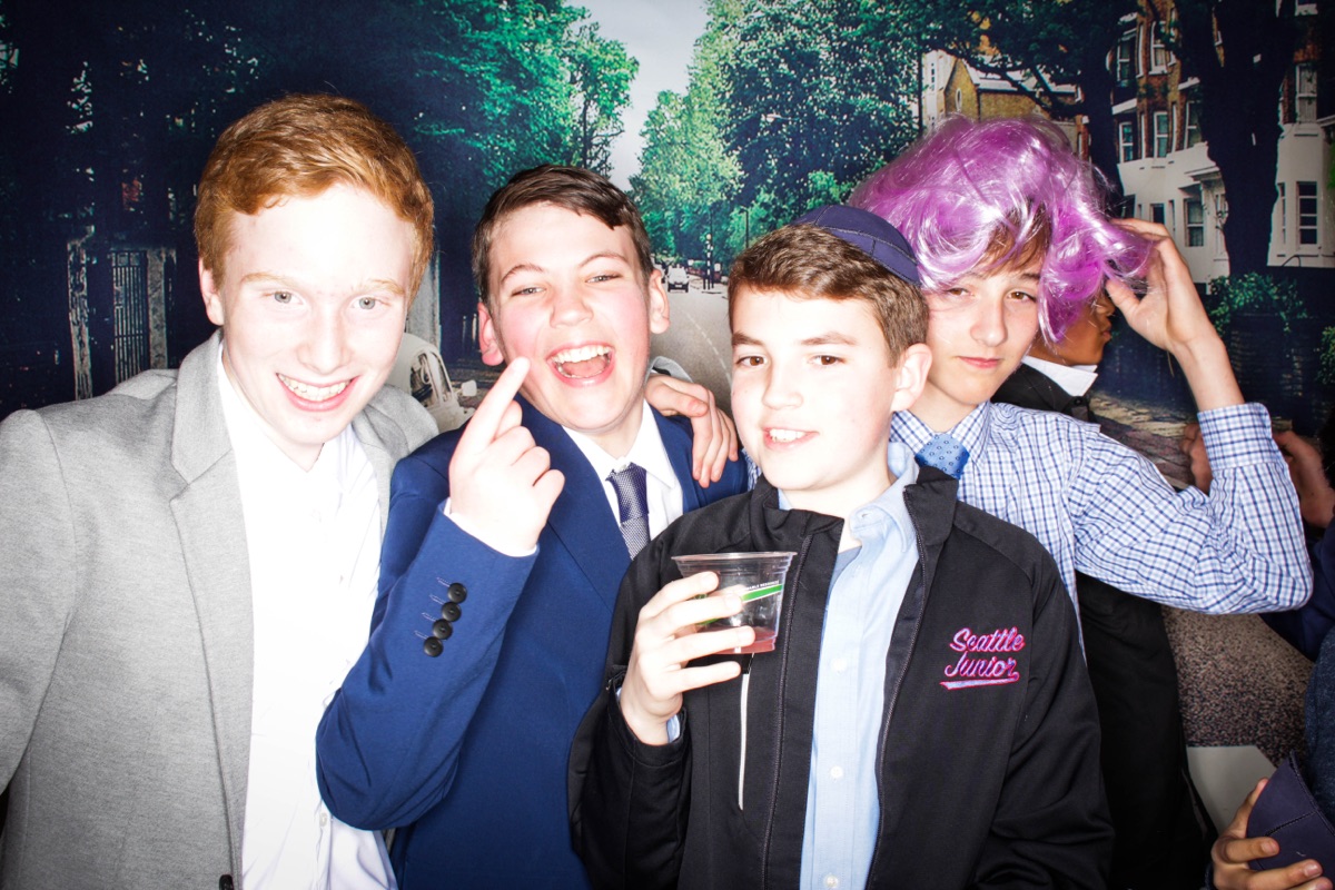 Photobooth: four friends, one in a kippah, one in a purple wig