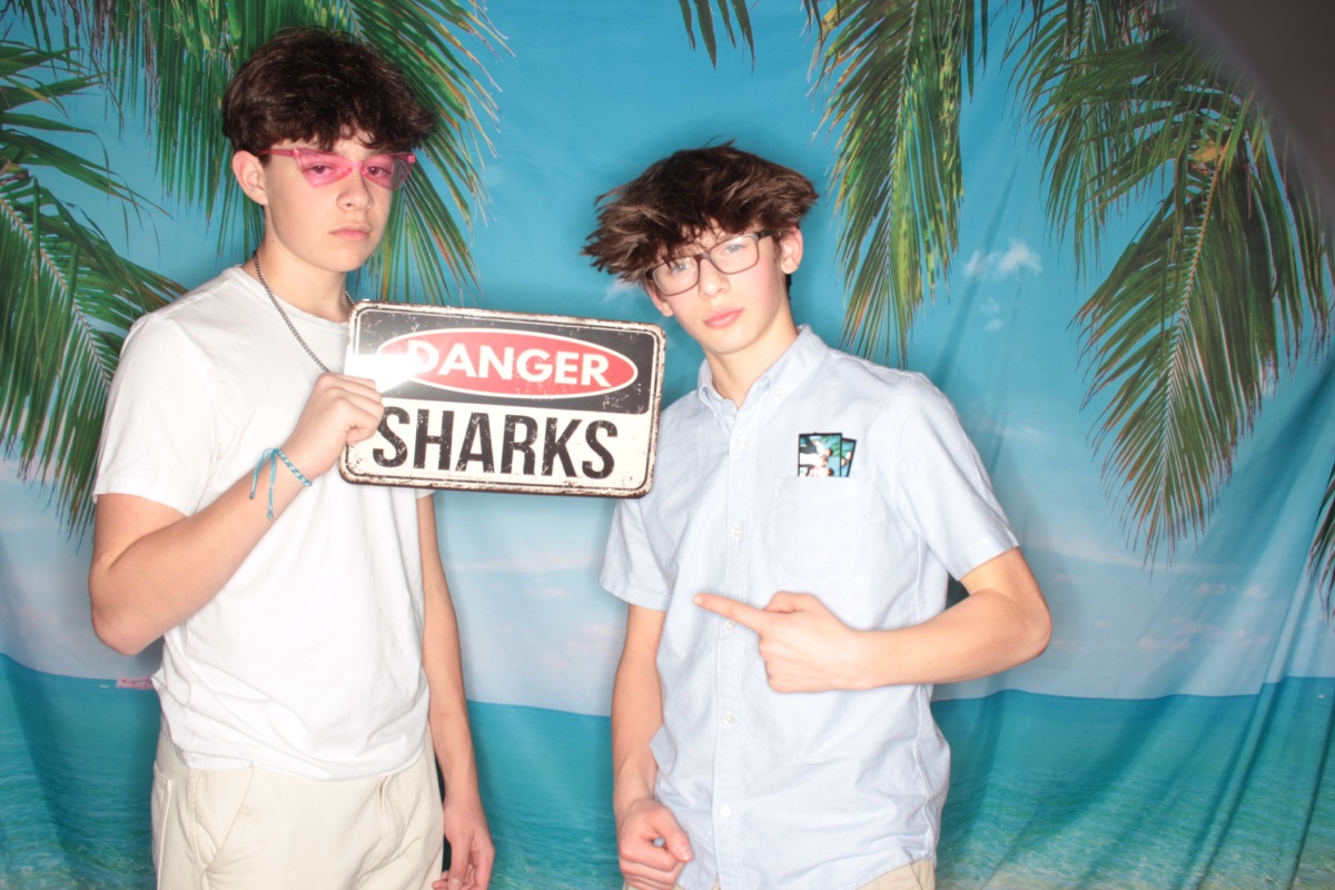 Photobooth: two friends with a Danger Sharks sign